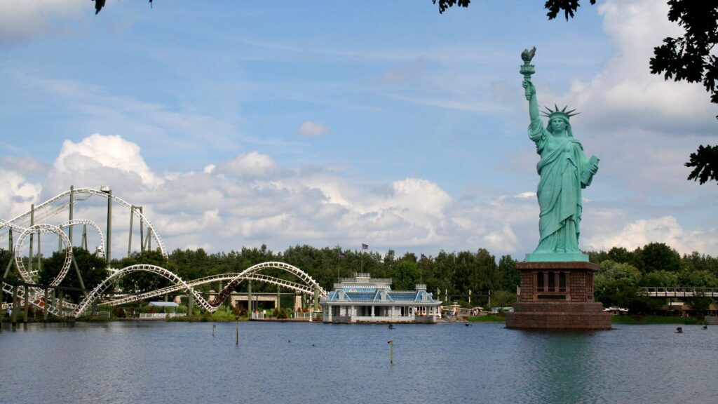 Blick über den Parksee auf Freiheitsstatue und Achterbahn im Heide Park Soltau
