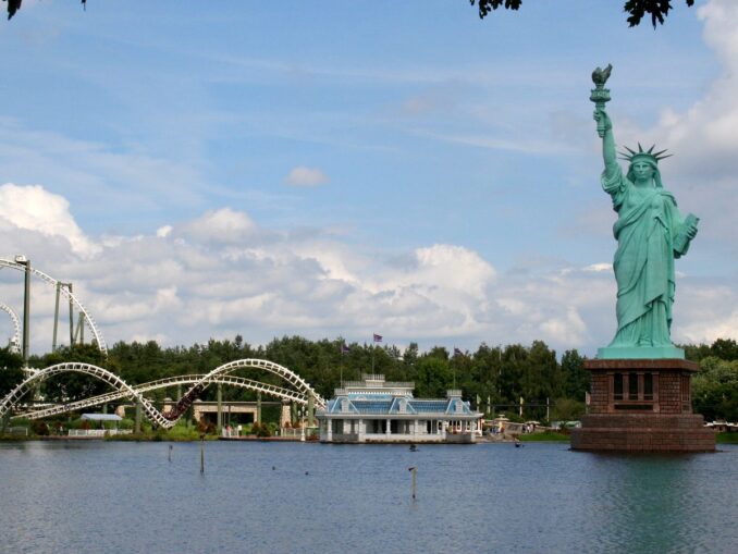 Blick über den Parksee auf Freiheitsstatue und Achterbahn im Heide Park Soltau