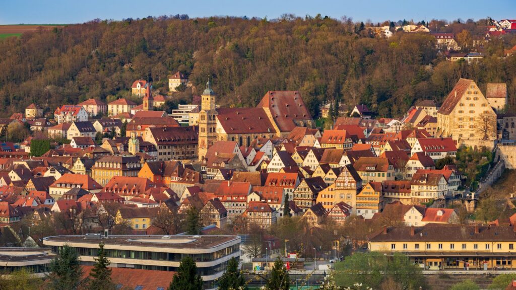 Altstadt von Schwäbisch Hall im Abendlicht mit Kirchturm und Kocherufer